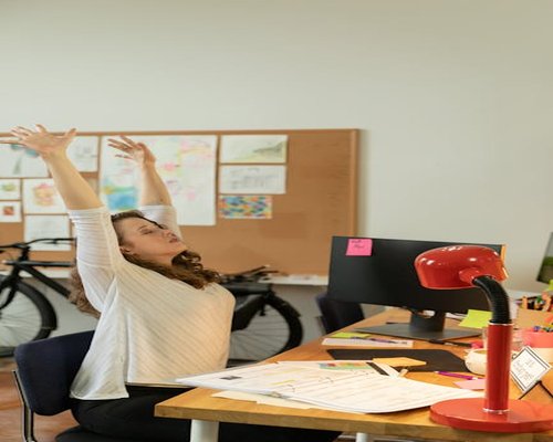 Person doing gentle stretching at the office desk